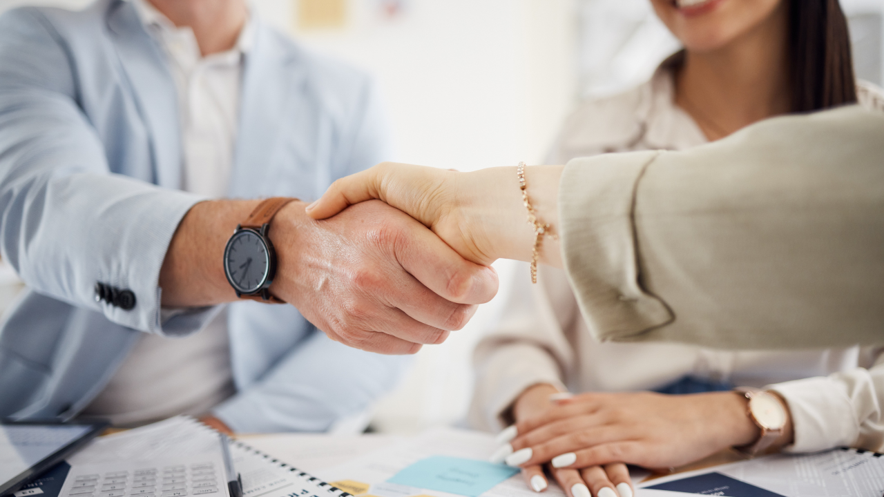 Business people, handshake and meeting in teamwork, hiring or partnership together at office. Closeup of employees shaking hands in team agreement, b2b deal or thank you in recruiting at workplace. Image Credit: Adobe Stock Images/peopleimages.com 